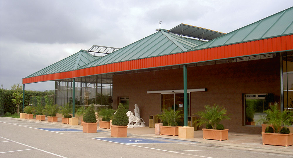 Exterior view of garden center with wide-span model and sloping front porch